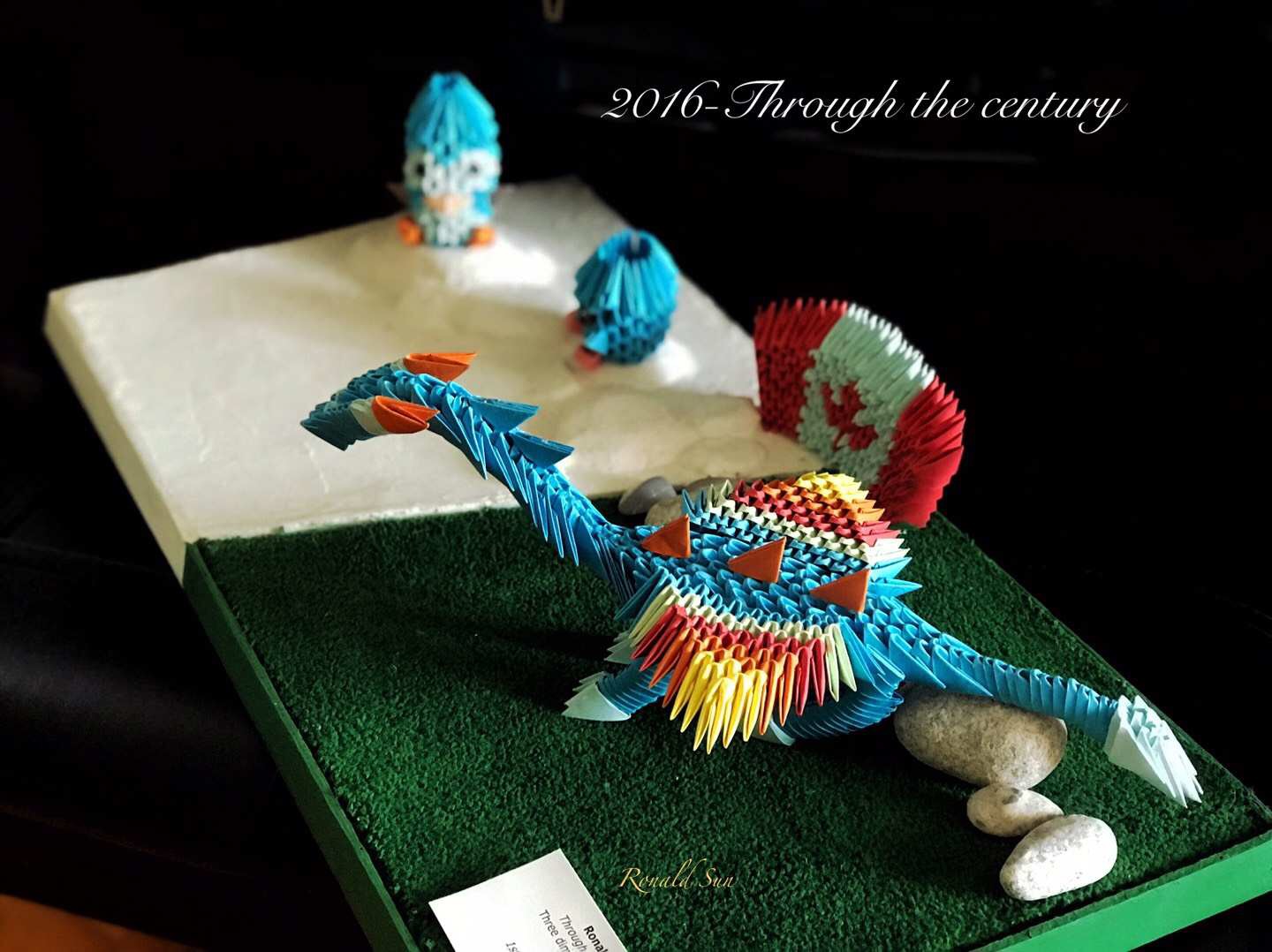 My creation portrays the coming together of creatures from two different eras, two different seasons who once lived in the same area. All of the components of my artwork were constructed from scratch, including the grass, the ice caps, and the origamis. I wanted to build this because I thought that it would be an interesting idea to combine two entirely different creatures into one artwork which conveys the message that humans, despite their many dissimilarities, have to potential to come together as a whole to make this world a better place.